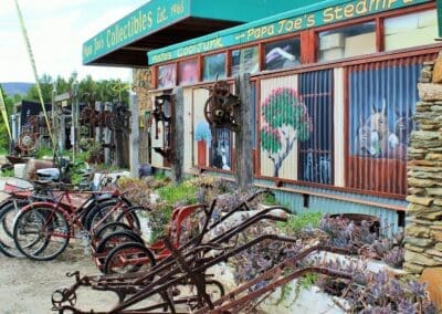 Papa Joe's Collectibles' shop in the background with farming equipment displayed on the pavement